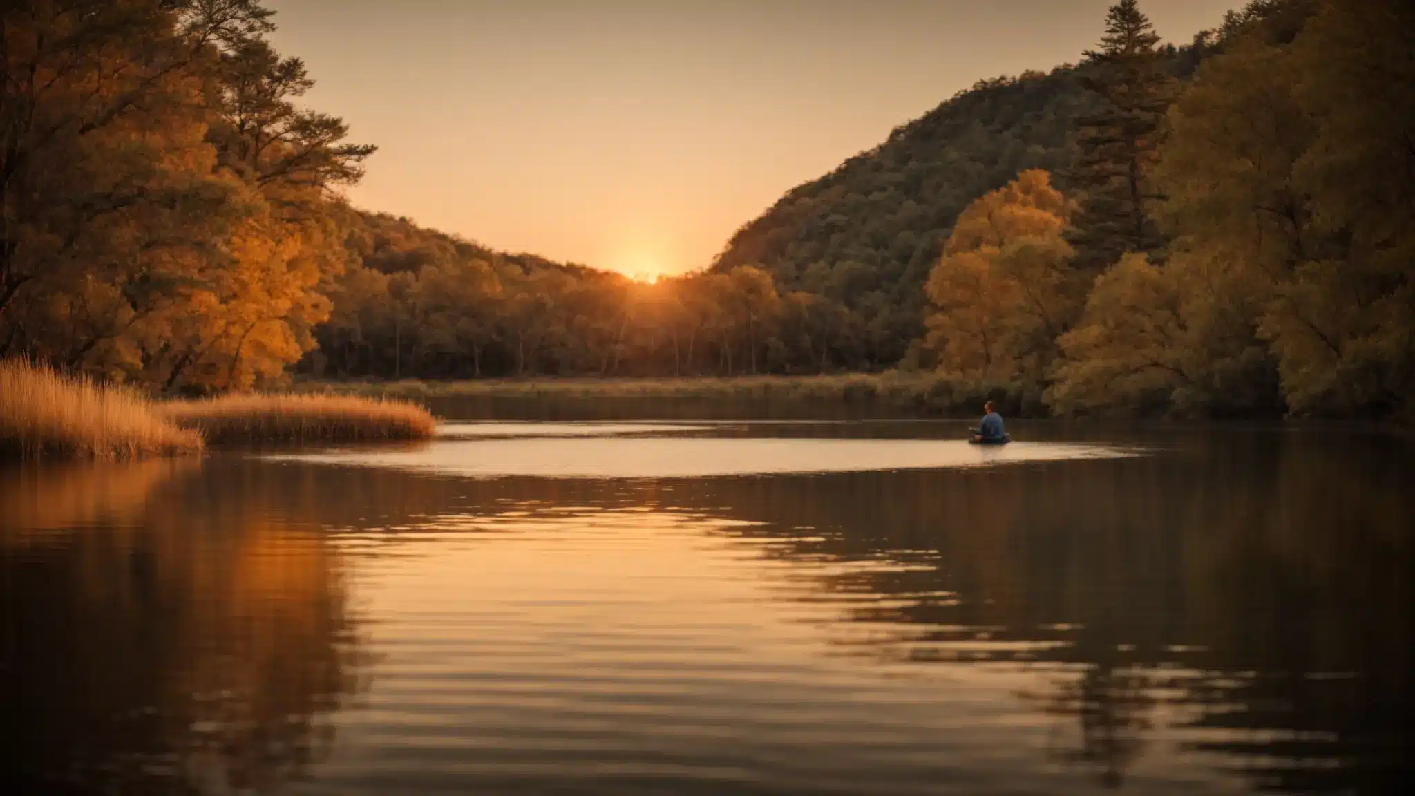 A serene lake at sunset with a single person meditating